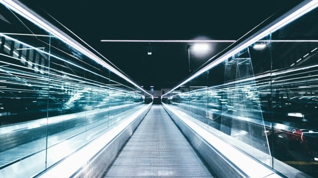 gray conveyor between glass frames at nighttime